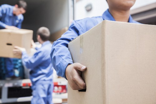 Professional movers handling household items in Acton