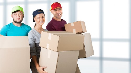 Professional movers handling office furniture