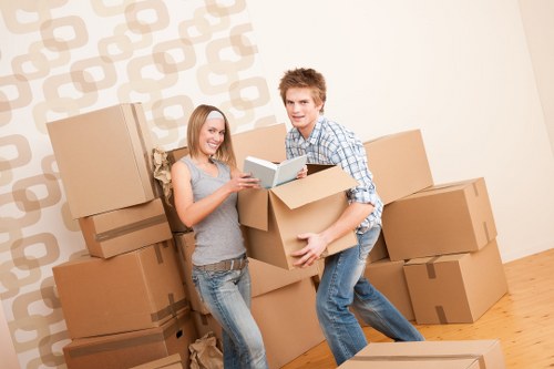 Professional movers handling office equipment